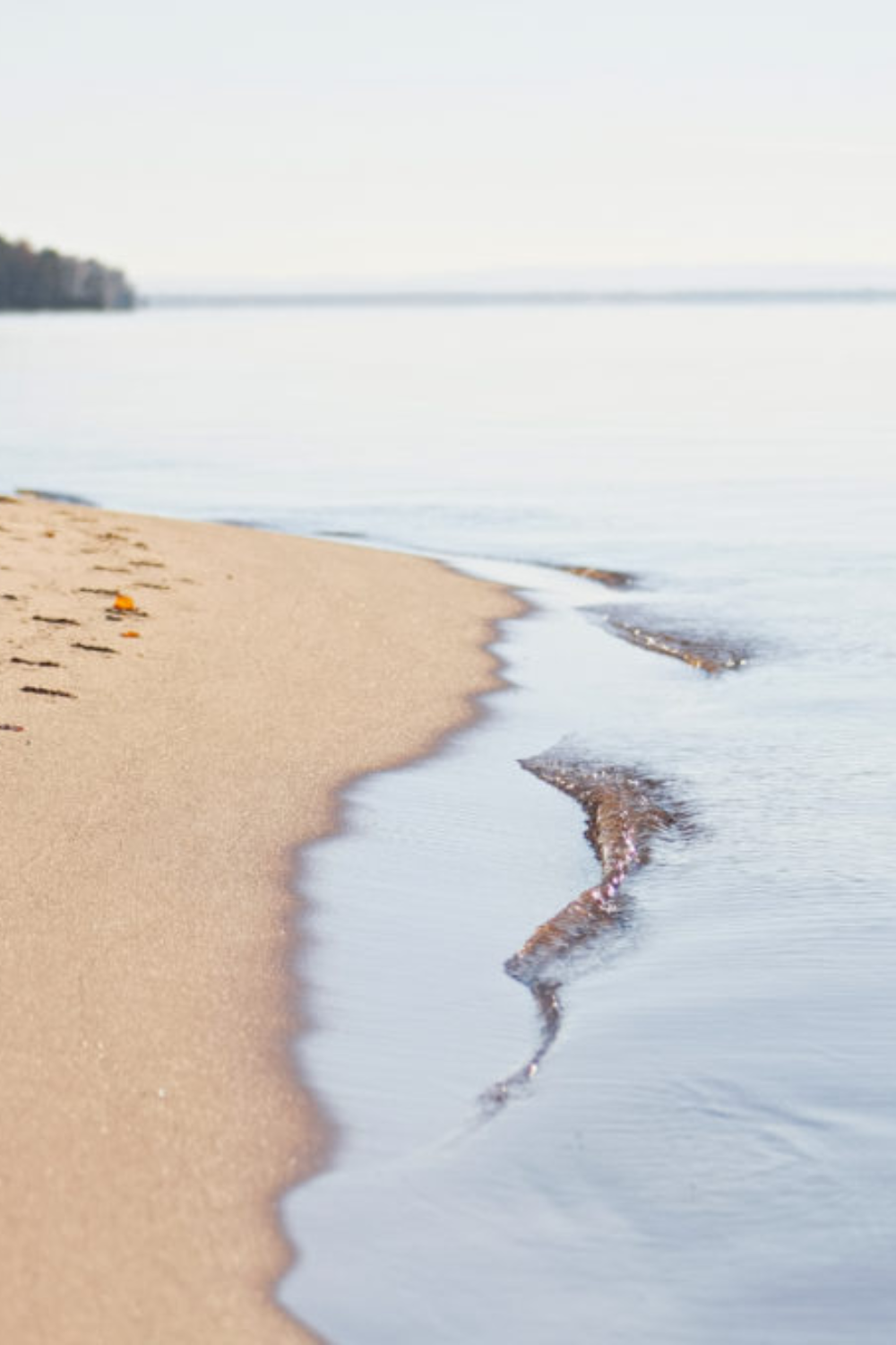 Glistening waters meet the sandy and rocky shores of Lake Superior.